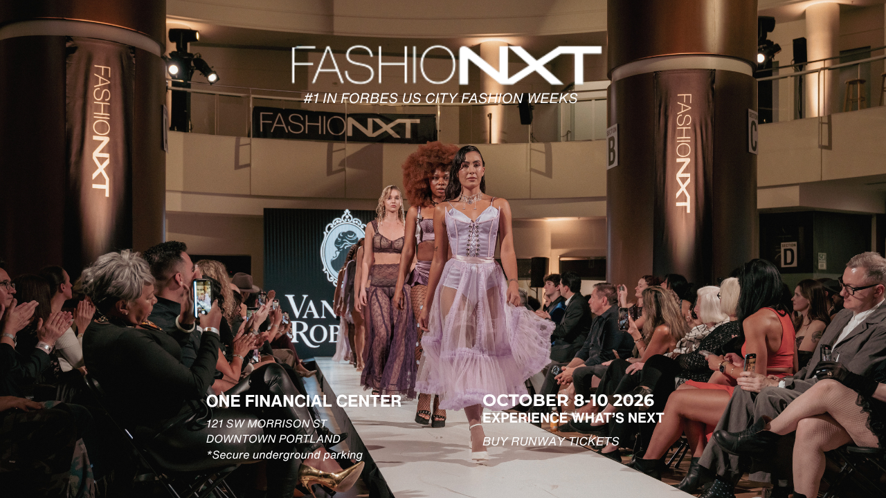 Three models in lavender dresses walk a fashion runway at FASHIONXT in Portland, surrounded by seated guests in an elegant venue with banners, spotlights, and event info overlayed on the image.