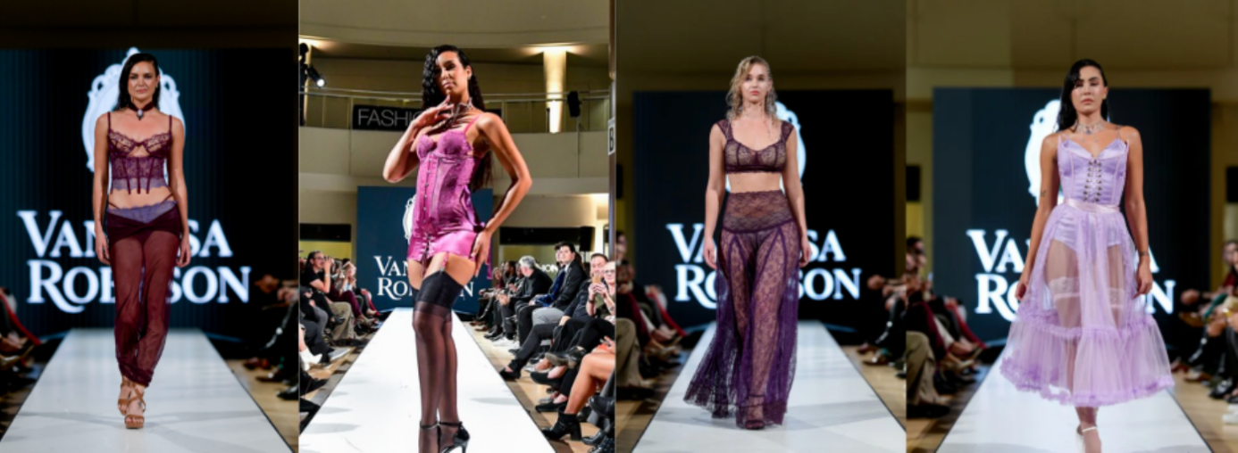 Four models walk a fashion runway wearing various purple and lavender lingerie outfits. The audience is seated on both sides of the runway, and a large "Vanessa Robson" sign is visible in the background.