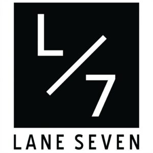 A black square logo with a white “L” and “7” separated by a diagonal slash, reflecting modern Portland fashion aesthetics. Below the square, the text reads “LANE SEVEN” in bold, uppercase letters.