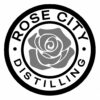 A circular logo with a stylized rose in the center evokes the spirit of Portland Fashion. The words “ROSE CITY DISTILLING” encircle the rose, separated by small dots.